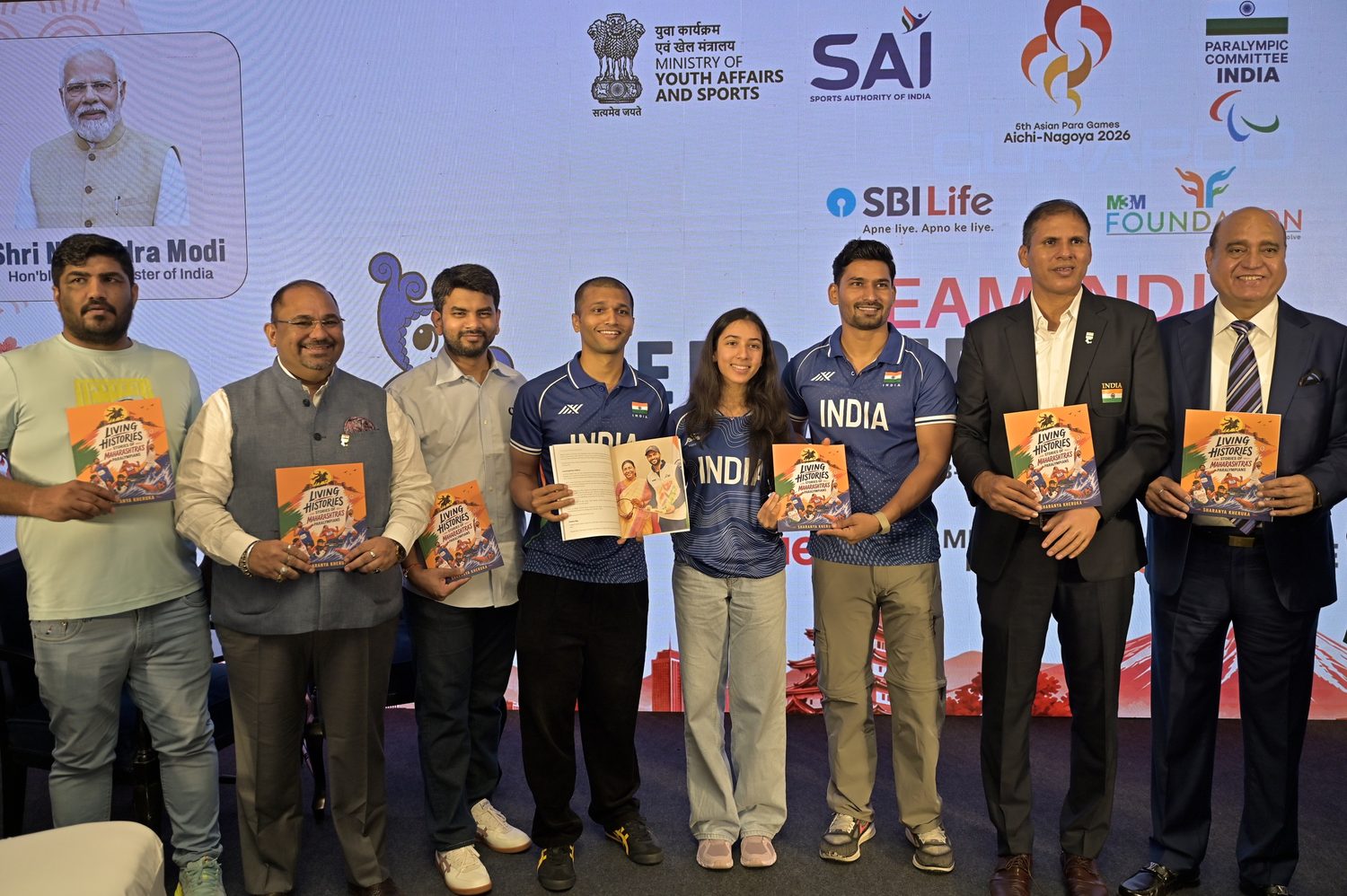 Sharanya Kheruka and eight others on stage holding copies of Living Histories
